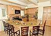 Kitchen with stainless appliances, granite counters, bar seating