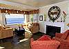 Living room overlooking ocean with fireplace