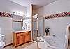 The master bath offers a large jetted-tub for soaking and a separate shower.