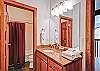 The second full bathroom is upstairs between the loft and the second bedroom.