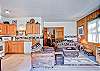 View of the living area and kitchen from the entry.  The couch is a sleeper sofa as well.