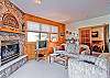 View of the living area from the entry.  The sofa is a sleeper sofa, making this a great condo for couples or families!