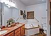 The master bath is complete with a two-person jetted-tub, separate shower and plenty of room.