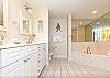 There is plenty of space to get ready with this double sink vanity in the master bathroom.