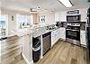 Full service kitchen with granite countertops and stainless steel appliances 