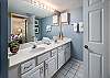 Large double vanity with full length mirror and shower/tub combination.