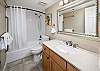 Brightly-lit guest bathroom offers a full shower/tub combo perfect for a quick shower before a night on the town!
