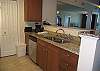 The kitchen looks out into dining and living areas.