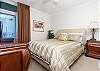 A queen size bed and incredible views grace the guest bedroom.