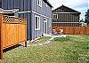 A nice hot tub behind the privacy screen and not the big fenced backyard. Barbeque is on the patio as well.