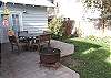 Established fruit trees and shrubs green up the fenced back yard.