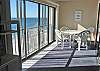 Glass enclosed balcony.  Can open sliding glass doors on rail.
