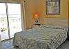 Additional view of bedroom 1 with access to balcony that overlooks Lagoon.