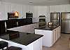 Large kitchen area. Includes 2 cooktops, 2 microwaves, 2 ovens, 2 refigerators, 2 dishwashers and 1 freezer in pantry.