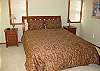 The Master Bedroom has a queen size bed.  There is a sliding glass door just to the left that leads to the top, west-facing deck.  The owner just put in a brand new mattress along with a featherbed top.