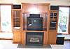 The entertainment center has a big TV, cable, and both a DVD and VCR hooked up through the amplifier.  You can also see the speakers for the surround sound.