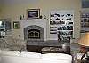 Beautiful and spacious living room with vaulted ceilings and enclosed fireplace.