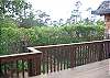 The backyard includes a large deck with a view to the ocean on a clear day.