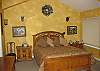This lovely bedroom is off of the main living area. It has its own private bathroom and wonderful ocean views from the windows on the right.