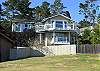 This is the back of the house.  You can see two of the four decks, especially the large deck at the top, where the gas BBQ is located.  You can also see that there is no house on this lot, making your ocean view that much better.