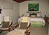 The master bedroom features a comfortable king-size bed, adjoining TV sitting area, private bath, and is privately located opposite the other bedrooms.