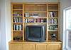 This bedroom has a nice TV as well as quite a few books to browse through.