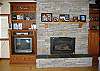 The living room boasts a stone fireplace and a nice TV with DVD player (and a few movies).  It has a craftsman-style vaulted ceiling, with large exposed beams.