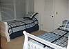 The bed on the right is a trundle bed, with another twin hiding underneath.
