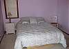 There is a queen bed in the purple bedroom.  There is a small, west-facing balcony off this bedroom.  The owner just put in a brand new featherbed top.  This bedroom is on the middle level, and shares a full bathroom with heated tile floors and heated towel racks.