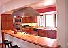 This house has a beautiful kitchen with stainless steel appliances,lots of limestone countertops, and plenty of room. The kitchen windows overlook the front gardens and water fountain.