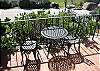 Enjoy the ocean and ranch views from this quaint table and chairs.
