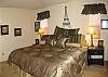This is a bright and comfortable master bedroom.  There is a patio off to the left, which lets you make the most of the nice ocean breeze.