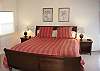 There is a king-sized bed in the master bedroom, which is on the upper level.
