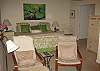 The master bedroom features a comfortable king-size bed, adjoining TV sitting area, private bath, and is privately located opposite the other bedrooms.