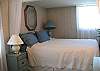Romantic canopy-illusion queen bed with matalesse coverlet.