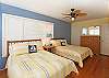 Second guest bedroom with two double beds.