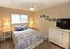 Queen bedroom with flat panel TV and nice furnishings.