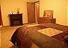 Master Bedroom with Faux Fireplace to keep you warm.