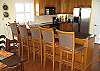 2nd Level:  The Kitchen overlooks the Dining Area and the Living Area, with seating for 5 at the bar.