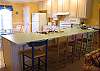 The eat-in kitchen area (as seen from the living area) with additional seating for four at the bar