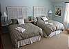 Main level bedroom with two queen beds and a private entrance to deck