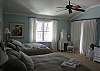 Another view of main level bedroom with two queen beds and private entrance to deck
