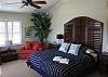 Main level king bedroom with Gulf views, two single fold-outs and private entrance to deck