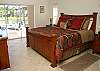 The Master suite has a King size bed with triple sliding glass doors overlooking the pool, spa and lake.