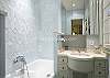 Clean white and blue tile keeps the second bathroom looking stunning