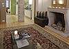 View from the Great Room towaards the back.  You can arrange candles in the fireplace.  The Brown unit to the left of the fireplace extends into a single bed. The sofa on the left folds out into a double bed.  The apartment can sleep up to 5 guests comfortably.