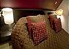 The master bedroom also features a queen size bed with a suitcase rack and ambient lights and reading lights.