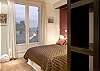 View as you enter the master bedroom with view of the book case and view from the terrace accessible directly from the bedroom.