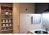 The kitchen is new but basic with a fridge, microwave, 2 top range. There is a large rack for your spices, dishes and other supplies.