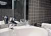 In the main bathroom, you have a full size luxury shower, a spacious sink and dressing area and a washer/dryer at your disposal.  There is also plenty of light.  In the secondary bathroom, you  have a separate sink, mirror and toilet at your disposal.